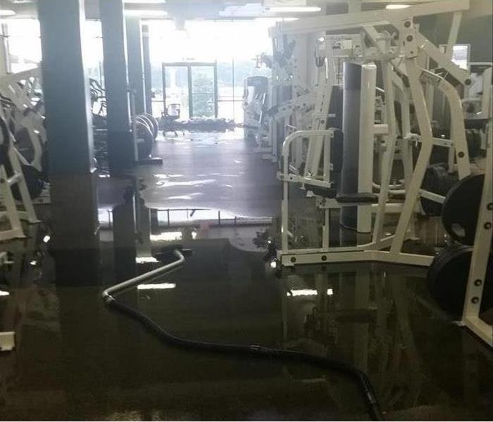 wet gym floor, hose for extracting, lots of equipment 