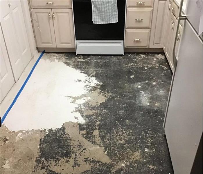 the floor is scraped of the tile and being prepared for a new one