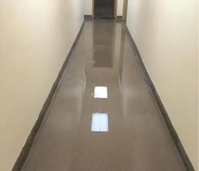 Corridor flooded and reflecting the ceiling lights