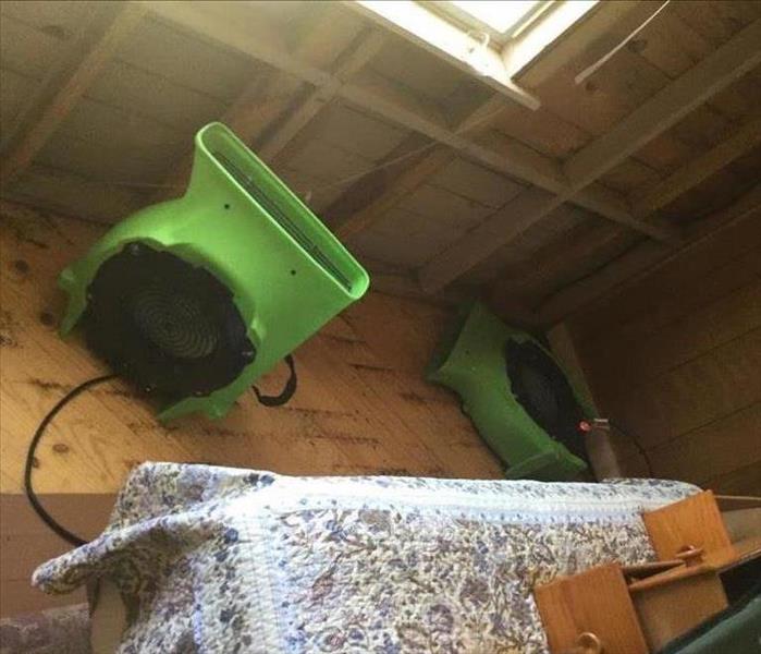 air movers set on a wooden floor drying out the enclosed porch
